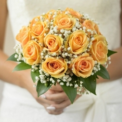 Nestled in the embrace of a bride strolling past the leafy paths of Canonbury Grove, this bouquet is quintessentially romantic and distinctly local. The blush of peachy-gold roses glows amid the subtle hush of white gypsophila, their finely clustered blossoms reminiscent of early morning mist across the Regent's Canal. Each rose, with its swirling petals combining sunlit yellow and gentle apricot shades, brings warmth and a sense of gently rising optimism-like the first rays that touch the garden walls along Alwyne Road. The touch of the bouquet is luxuriously rich: velvety-soft petals invite fingertips, while the delicate clouds of baby's breath add a feathery texture that lightens the whole composition. Framed in crisp green, the foliage introduces a cool, refreshing contrast-much like the tranquil gardens behind Canonbury's elegant Georgian terraces. Held against a backdrop of soft daylight filtering through nuptial spaces, the bouquet appears to glow from within, its vibrancy enhanced by the care of Canonbury's expert florists. Each detail reflects an assurance that this arrangement is more than ornamental; it is a loving expression, carrying the warmth of the area, gentle affection, and enduring love for a lifetime. The scent is a subtle blend, uplifting yet not overpowering, making the bouquet a poetic companion for wedding vows and celebrations near Upper Street or Mildmay. Carefully prepared for same-day delivery throughout Canonbury and neighbouring districts, this bouquet carries not only flowers but the spirit and sincerity of local craftsmanship.